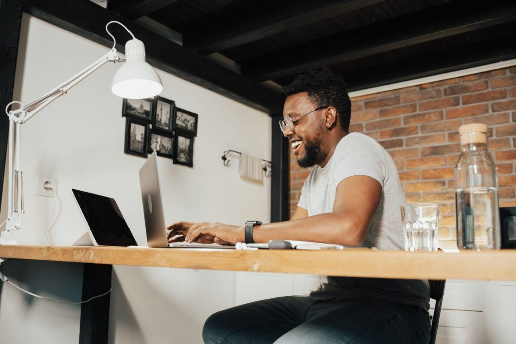Man working remotely on a laptop in a home office